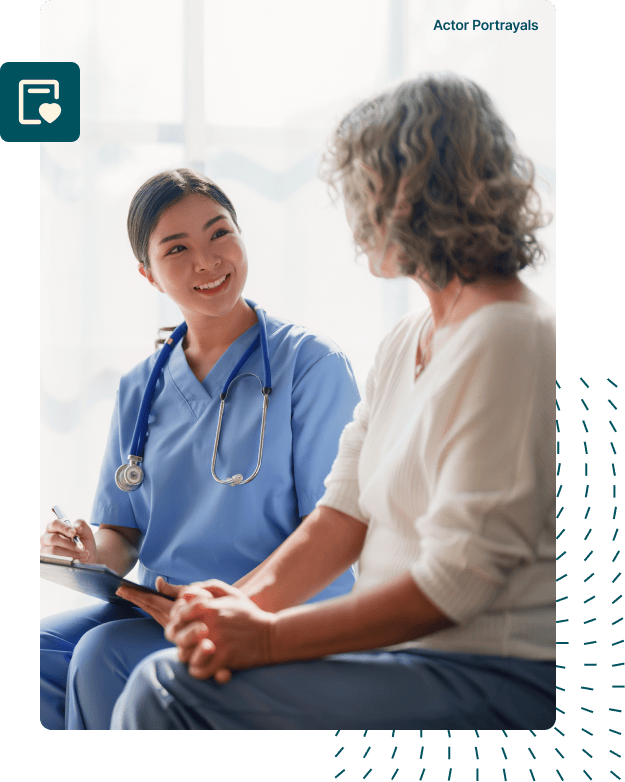 A doctor wearing a white lab coat smiling warmly at a patient seated in front of them, conveying empathy and reassurance during a medical consultation.